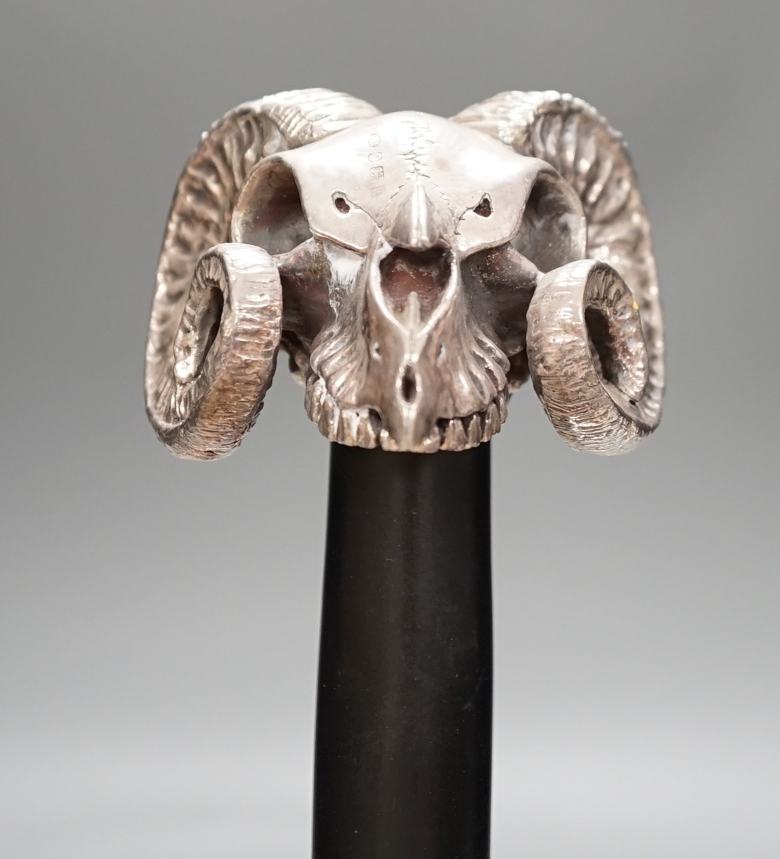 A Jeffery West umbrella with modern filled silver ram skull handle